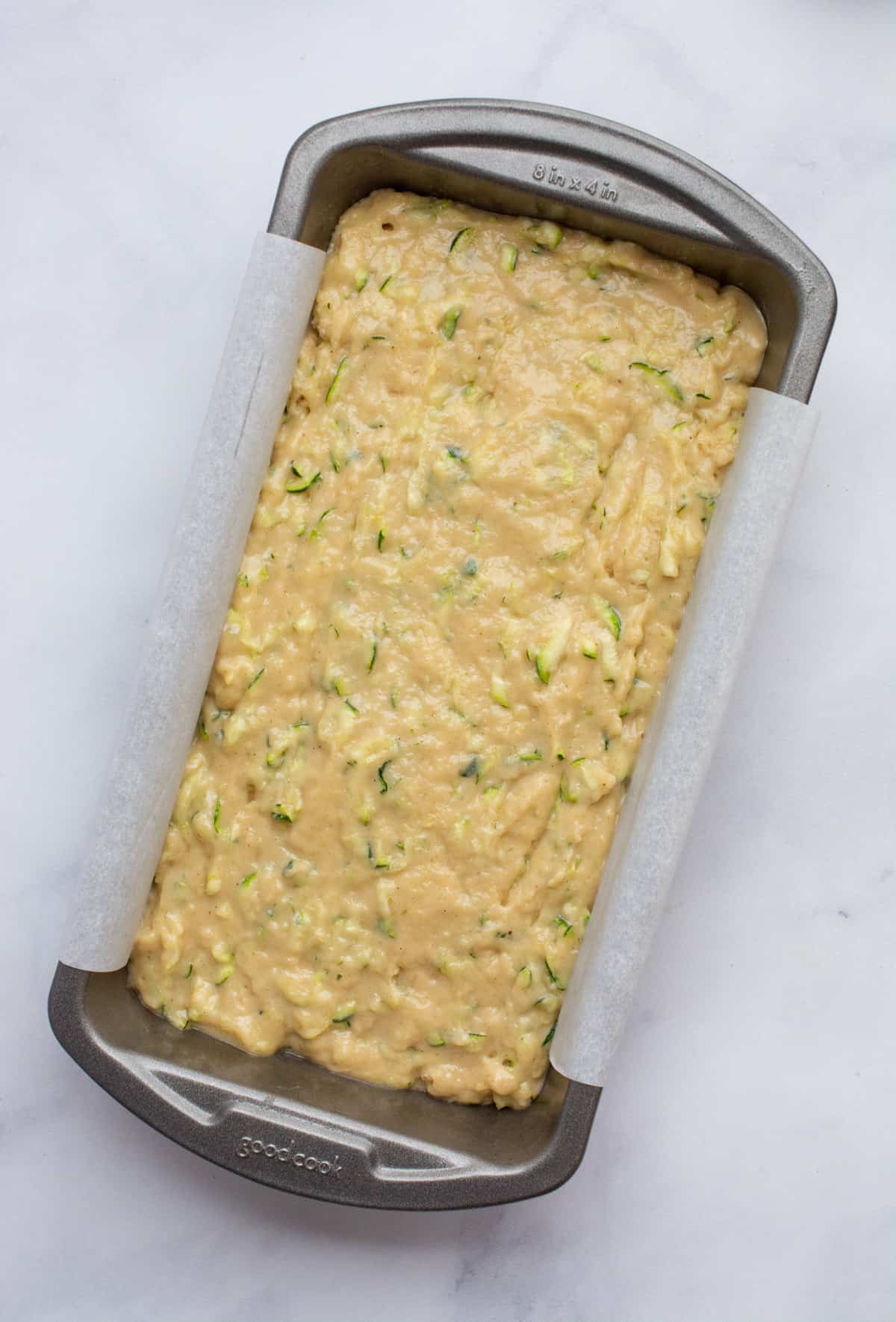 Zucchini bread batter in a loaf pan.