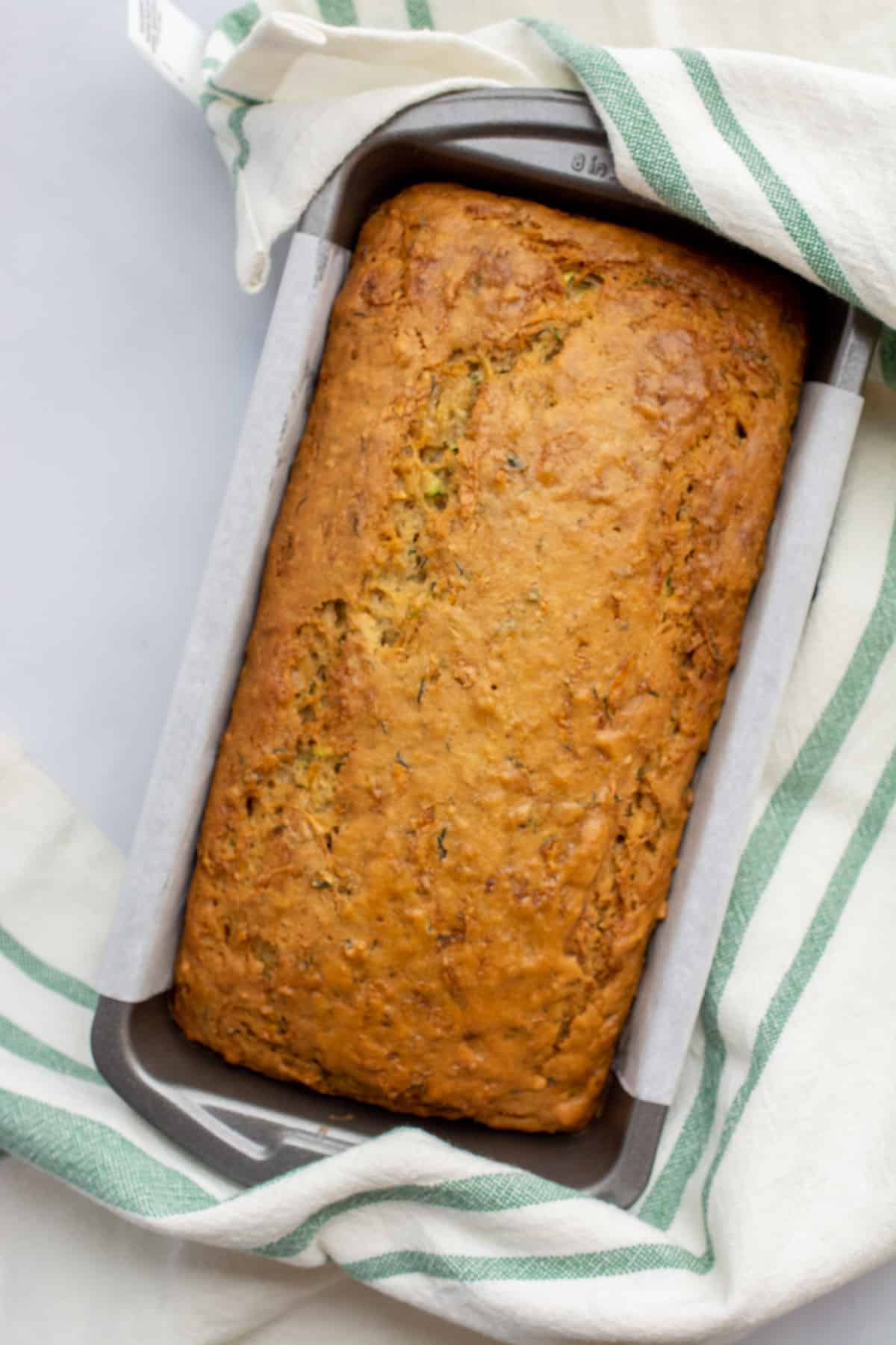 Vegan zucchini bread in a loaf pan after baking.