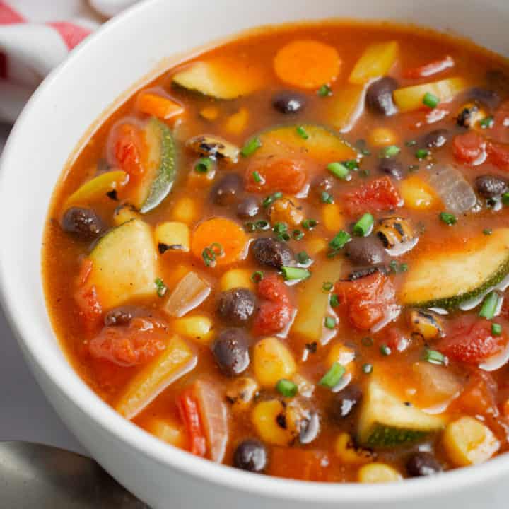 Instant Pot Southwest Vegetable soup in a white bowl topped with chives.