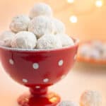 Wedding cookies in a red dish.