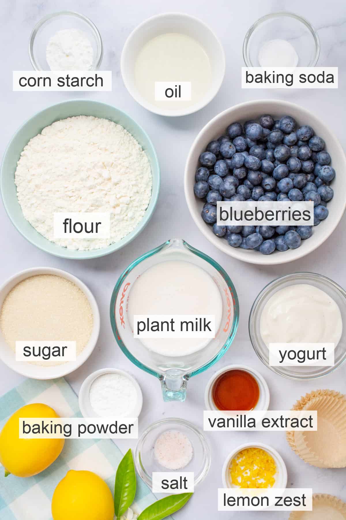 Vegan blueberry muffin ingredients in separate bowls.