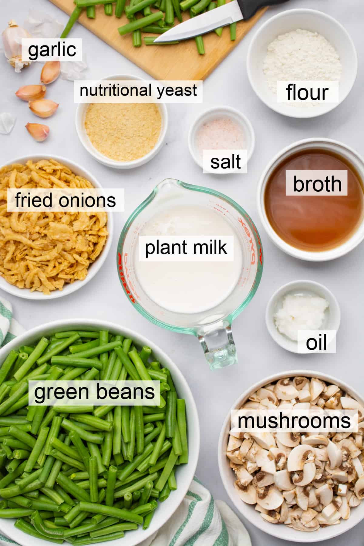 Ingredients in separate bowls to make vegan green bean casserole.