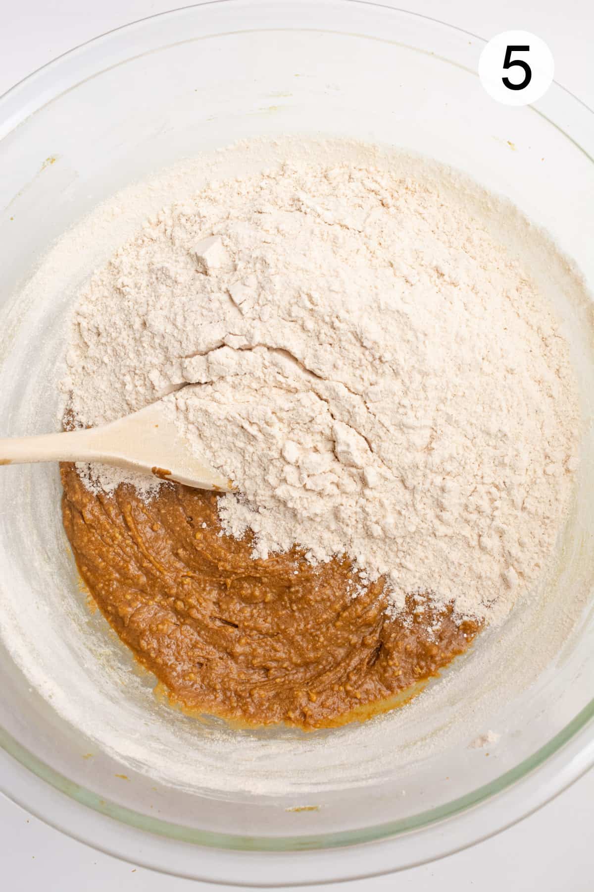 Flour being added to a bowl.