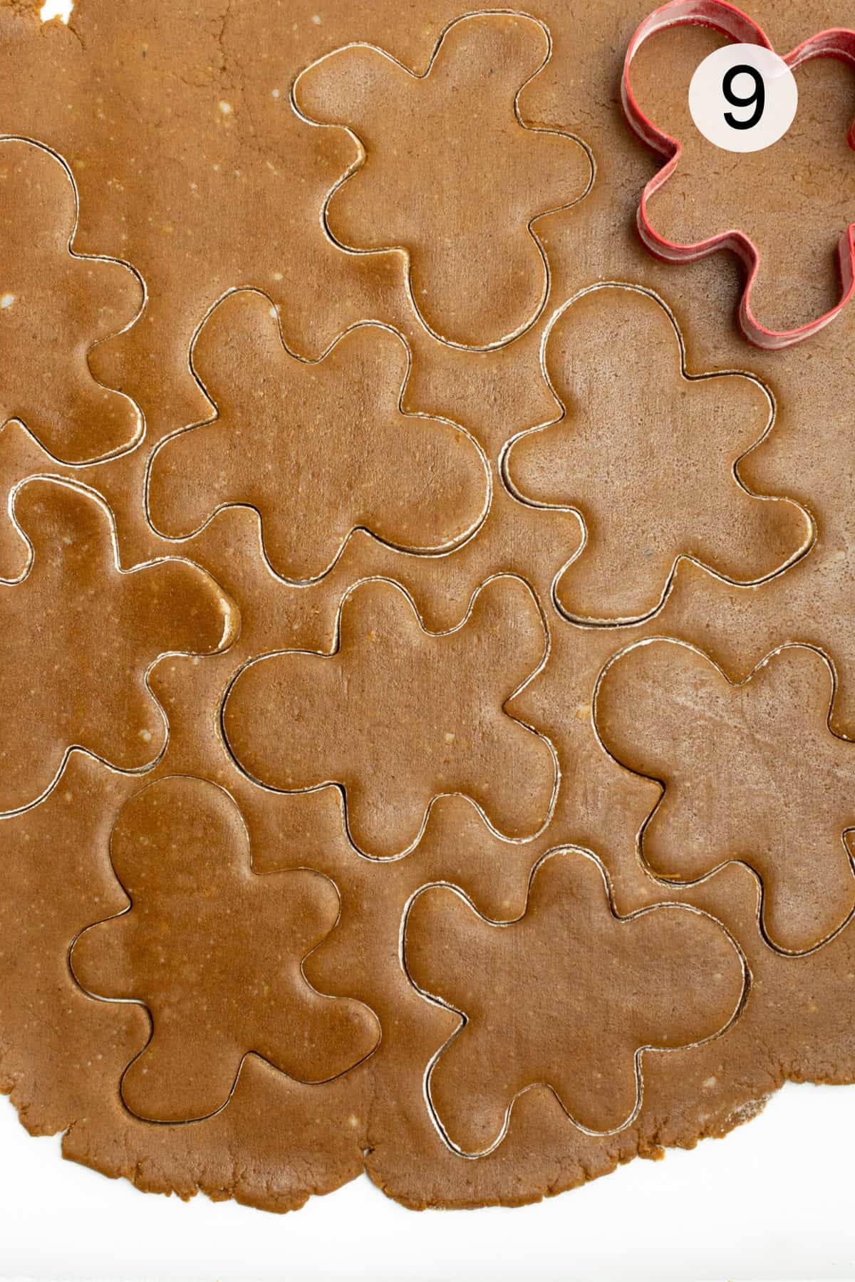 gingerbread cookie dough being cut out.