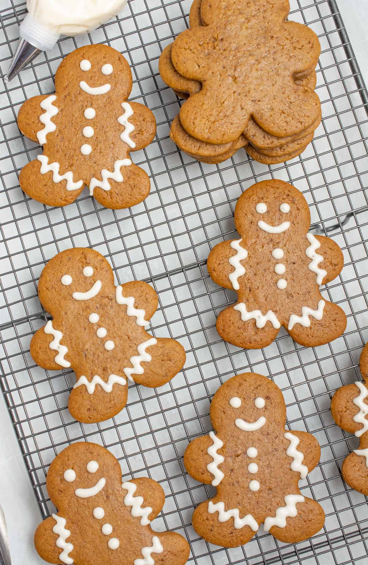 Vegan gingerbread cookies decorated on a cooling rack.