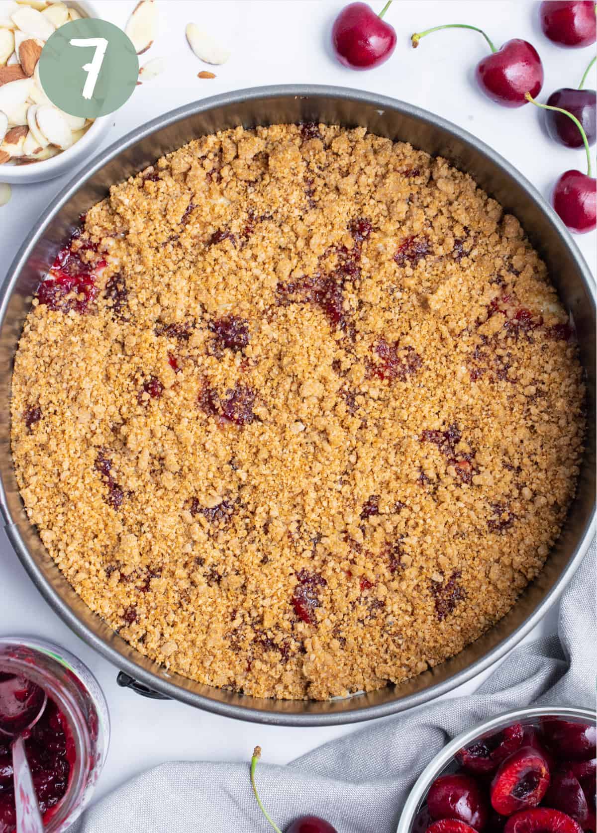 Crumb topping sprinkled across coffee cake batter.