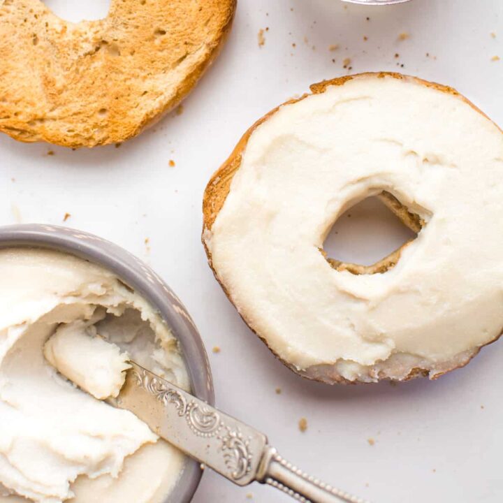 Toasted bagel topped with vegan cream cheese.