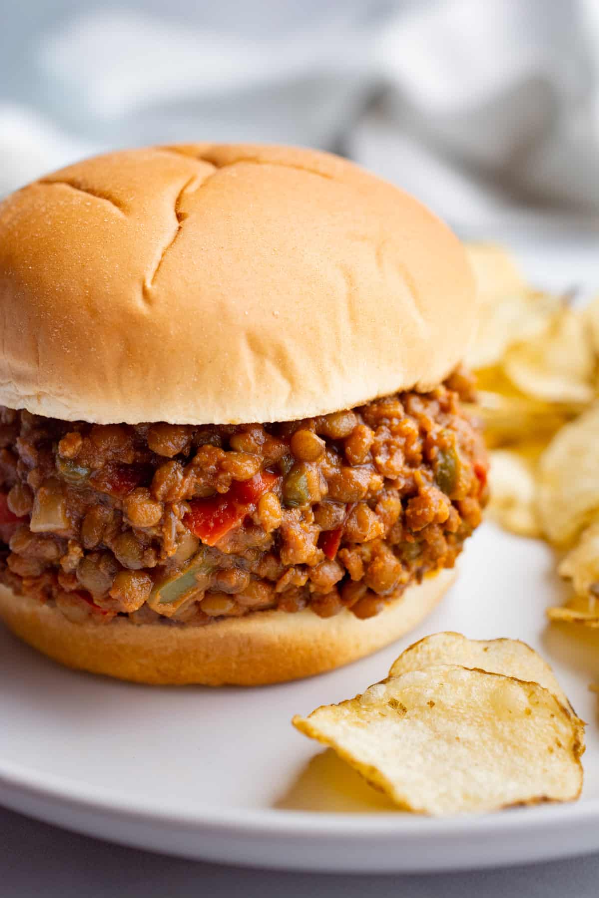Vegan sloppy joes with lentil "meat" on a white plate.