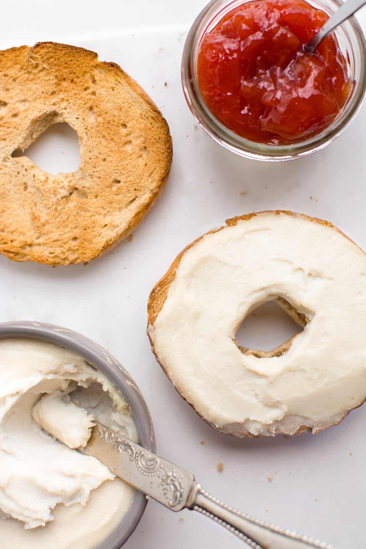 Cashew cream cheese spread on a toasted bagel.