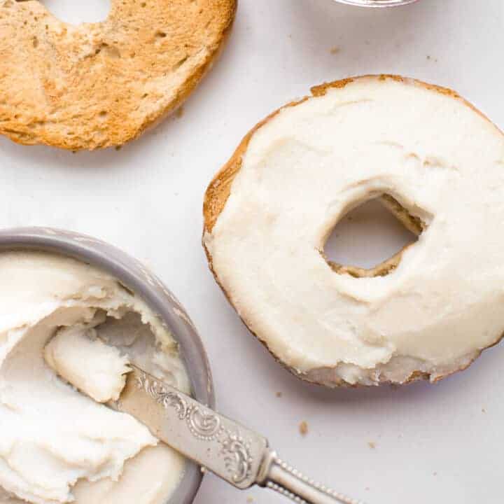 Toasted bagel topped with vegan cream cheese.