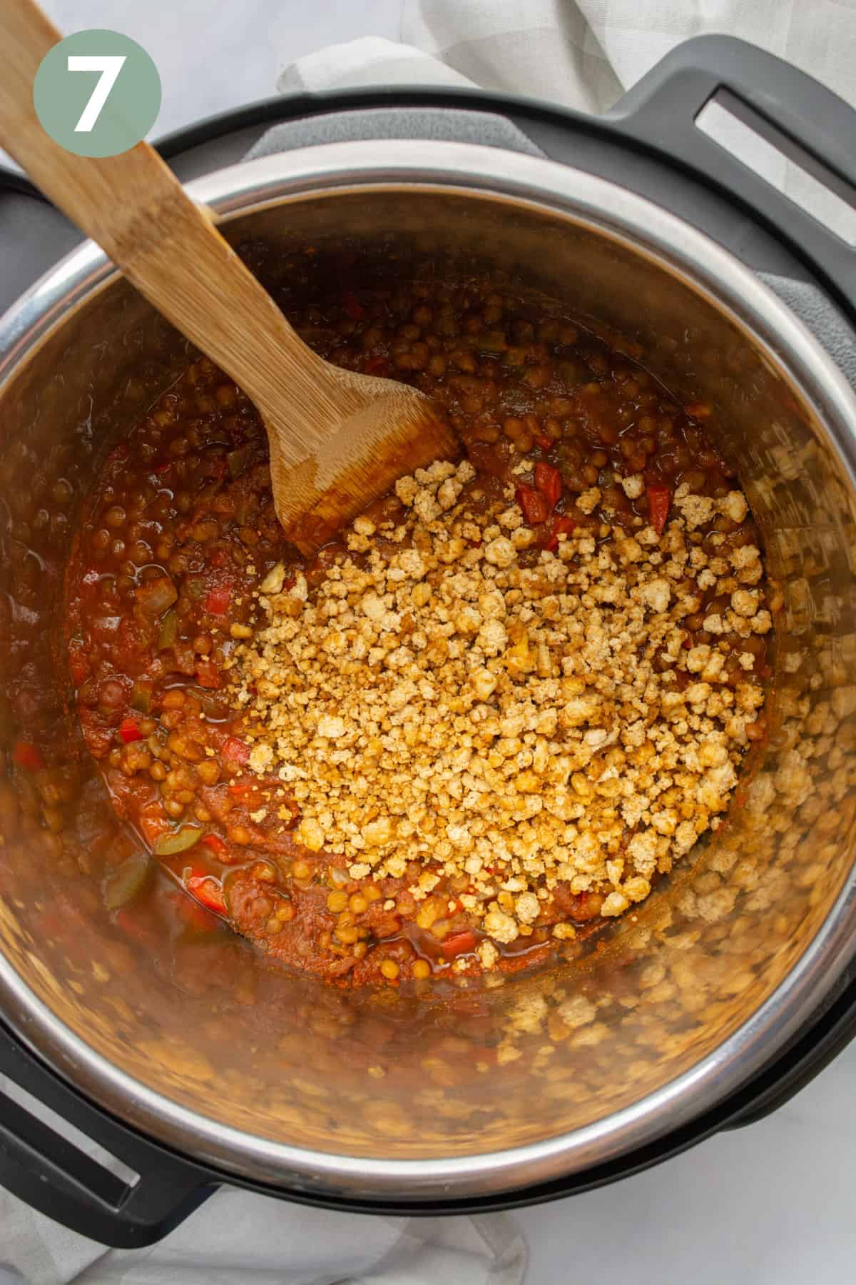 Baked tofu crumbles added to a lentil sloppy joes mixture in the Instant Pot.