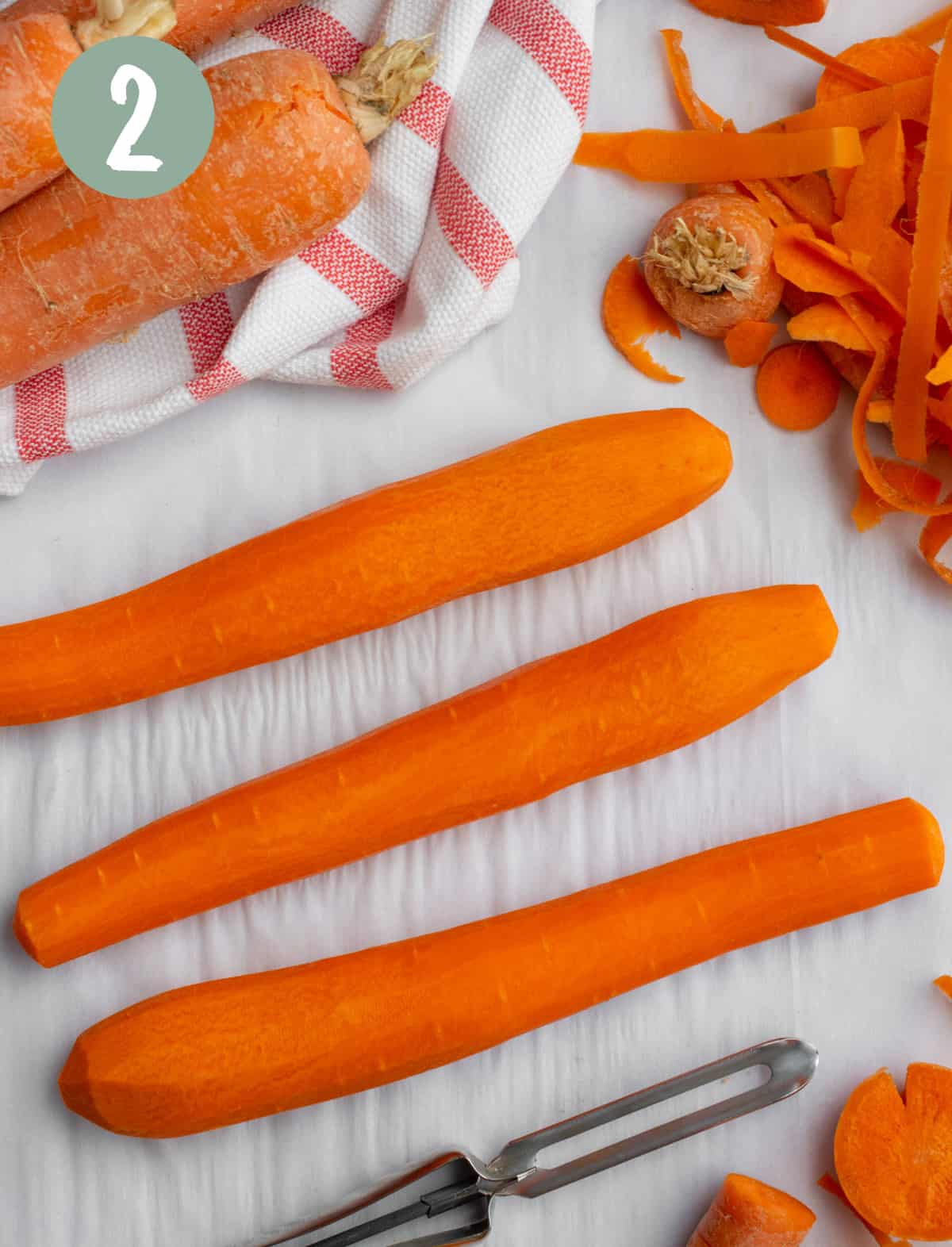 Three carrots peeled and ends rounded to resemble a hotdog.