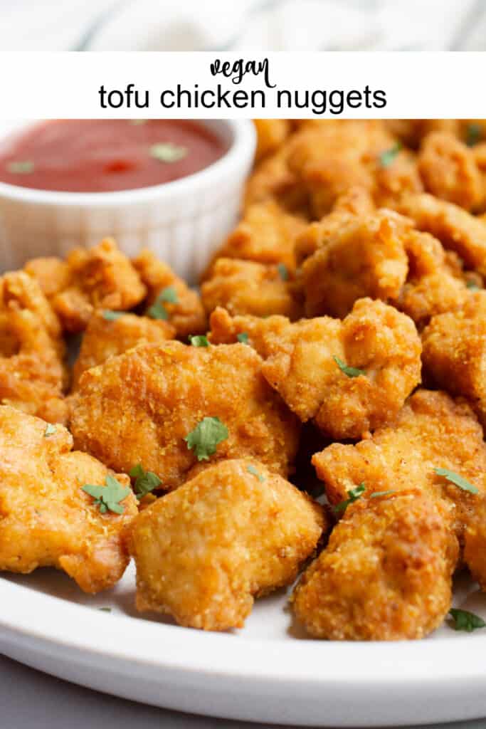 Tofu chicken nuggets on a plate with bbq dipping sauce.