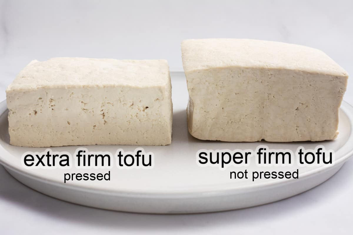 A block of pressed extra firm tofu and a block of super firm tofu side by side on a plate.