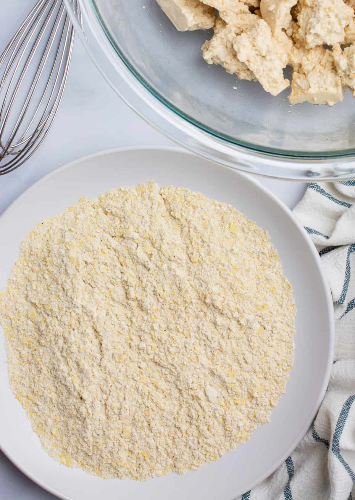 A shallow bowl with a flour mixture for breading.