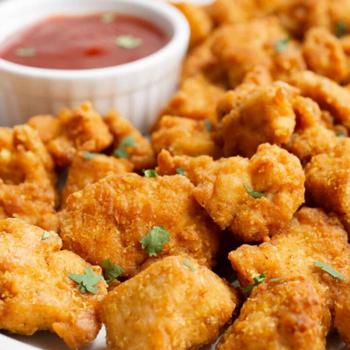Breaded tofu nuggets with dipping sauce.