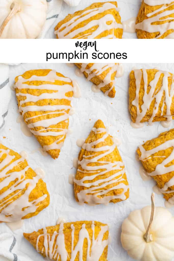 Vegan pumpkin scones drizzled with glaze on parchment paper.