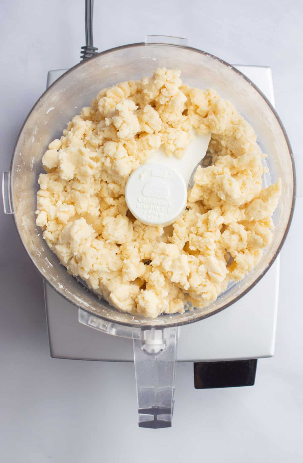 Dough for vegan pie crust in a food processor.