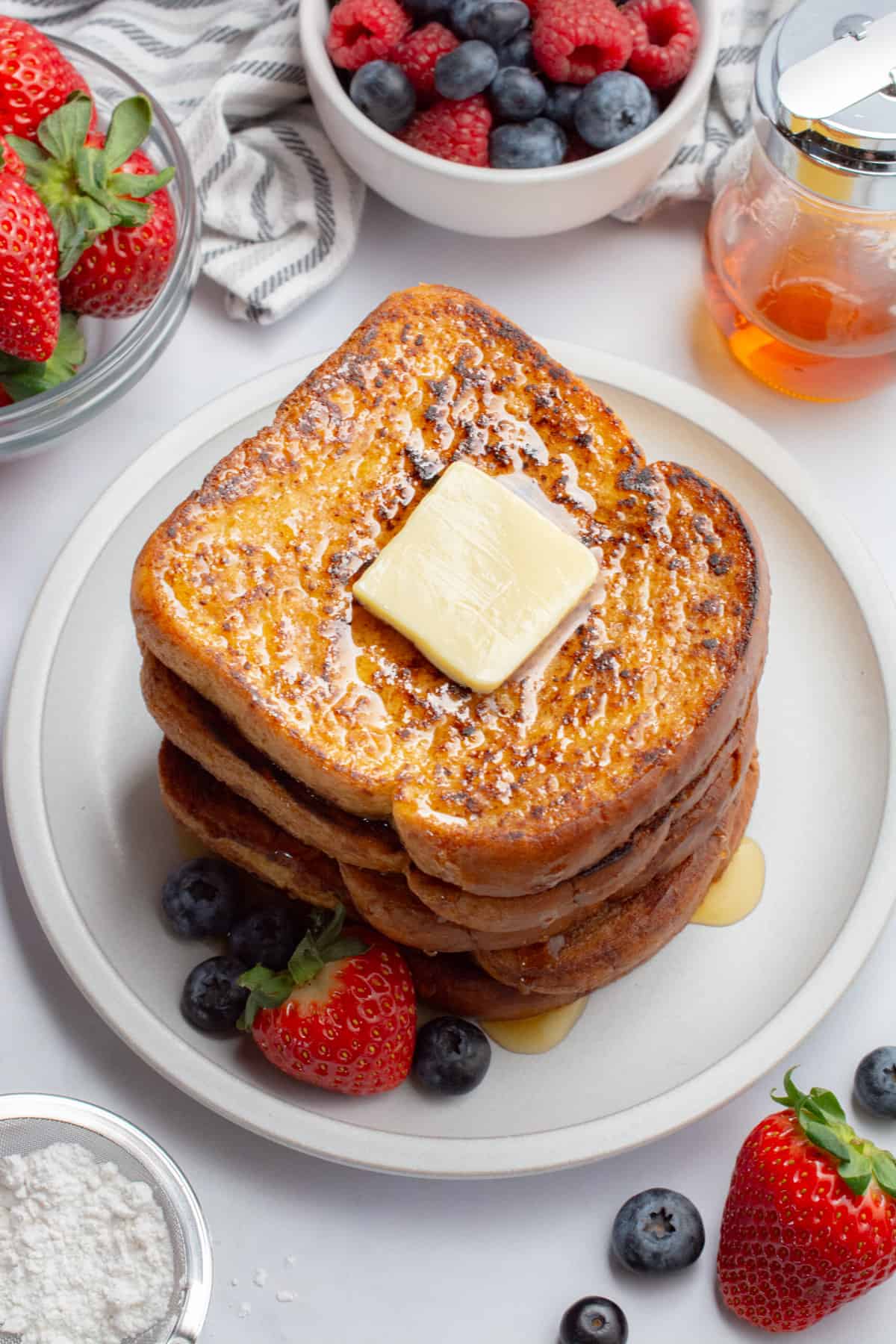 Vegan french toast with butter and berries.