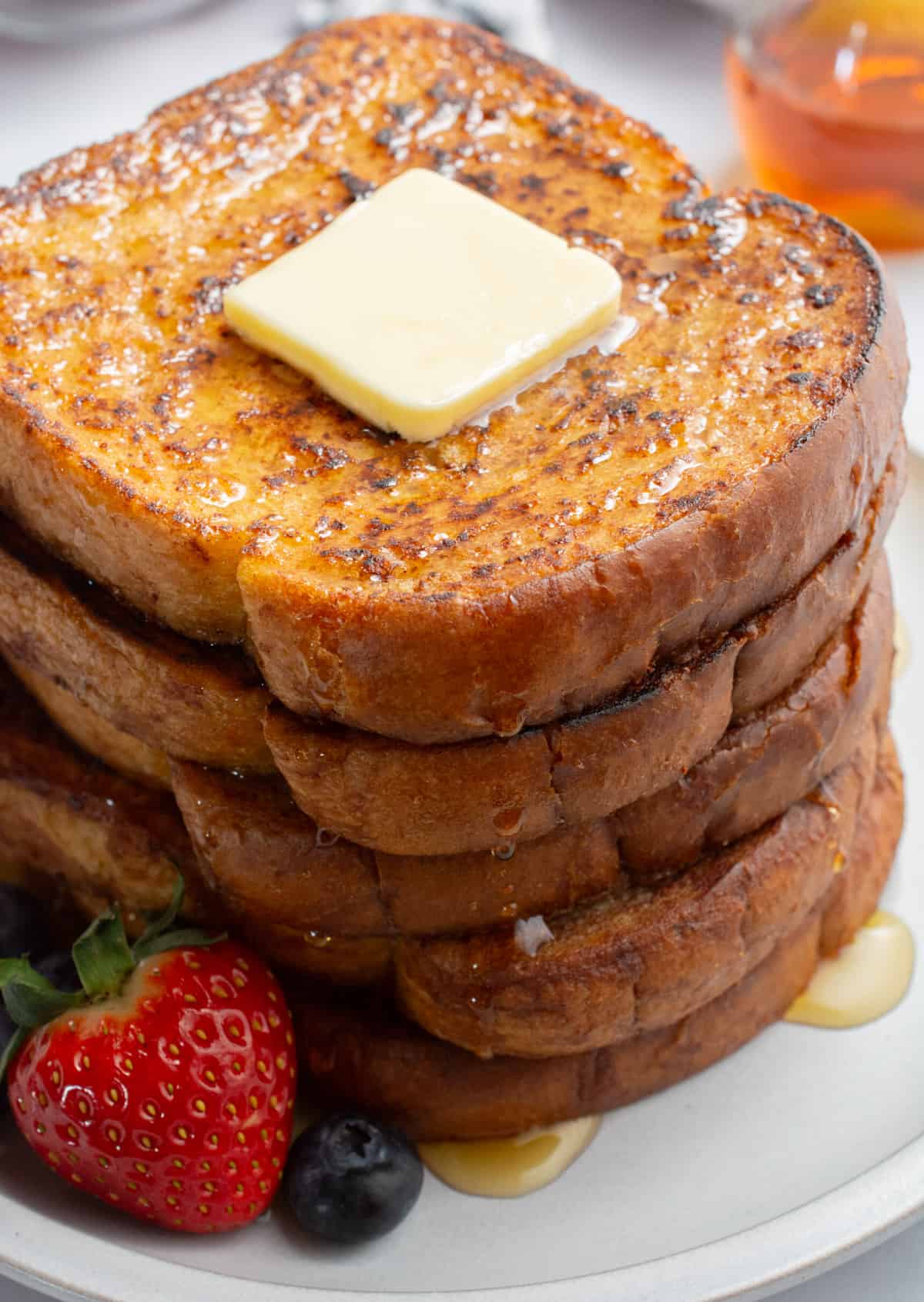 Eggless french toast with butter and maple syrup.