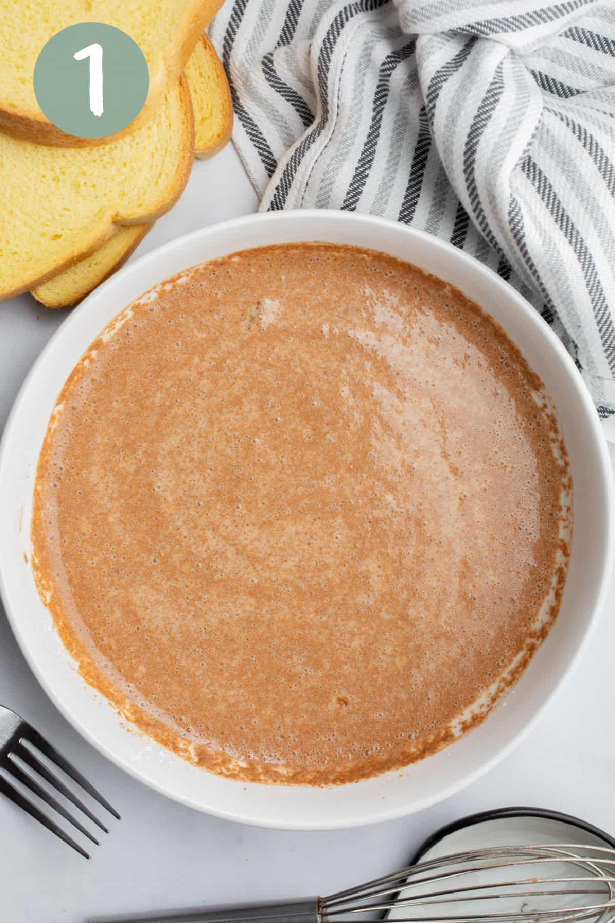 A shallow white bowl of batter for vegan french toast.