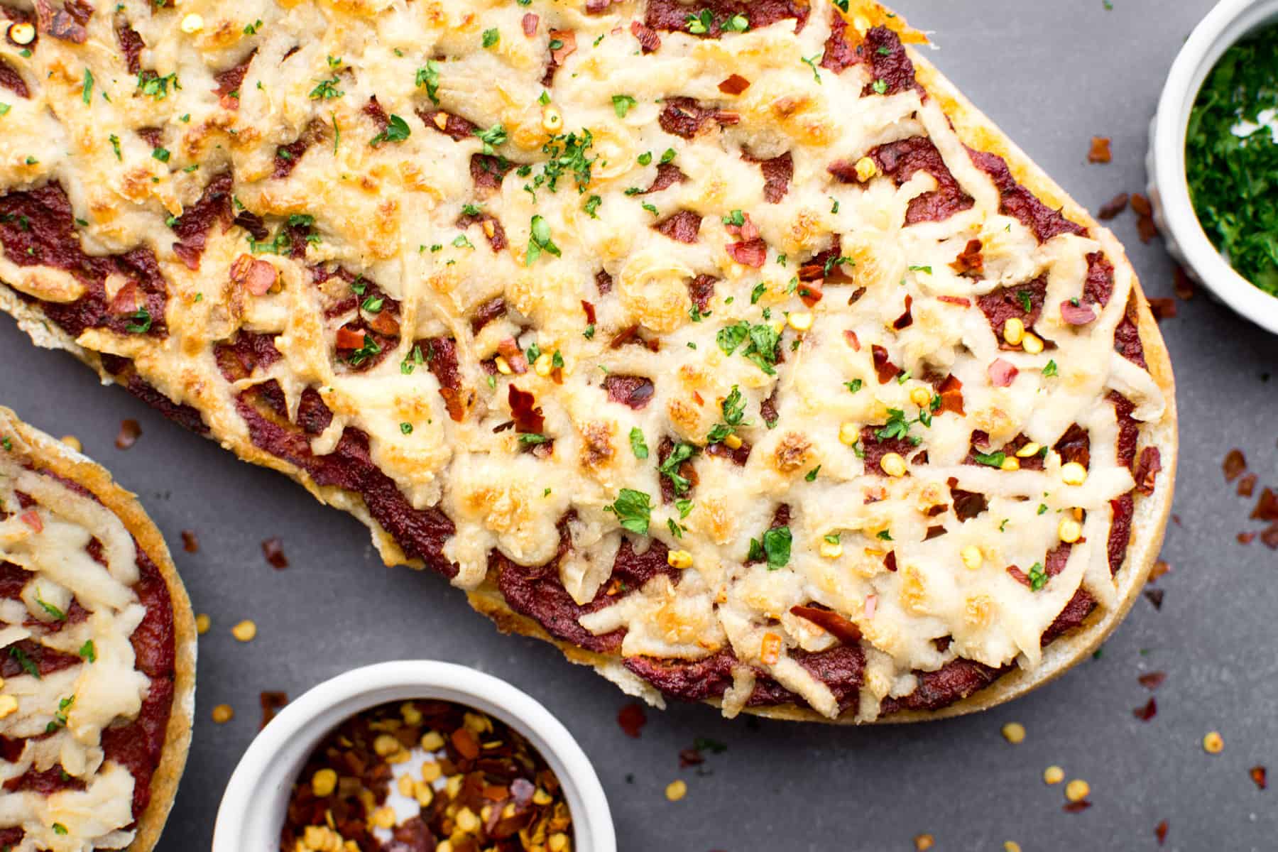 Vegan French bread pizza topped with cheese.