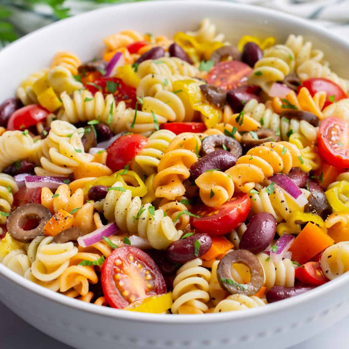 vegan pasta salad in a white serving bowl.