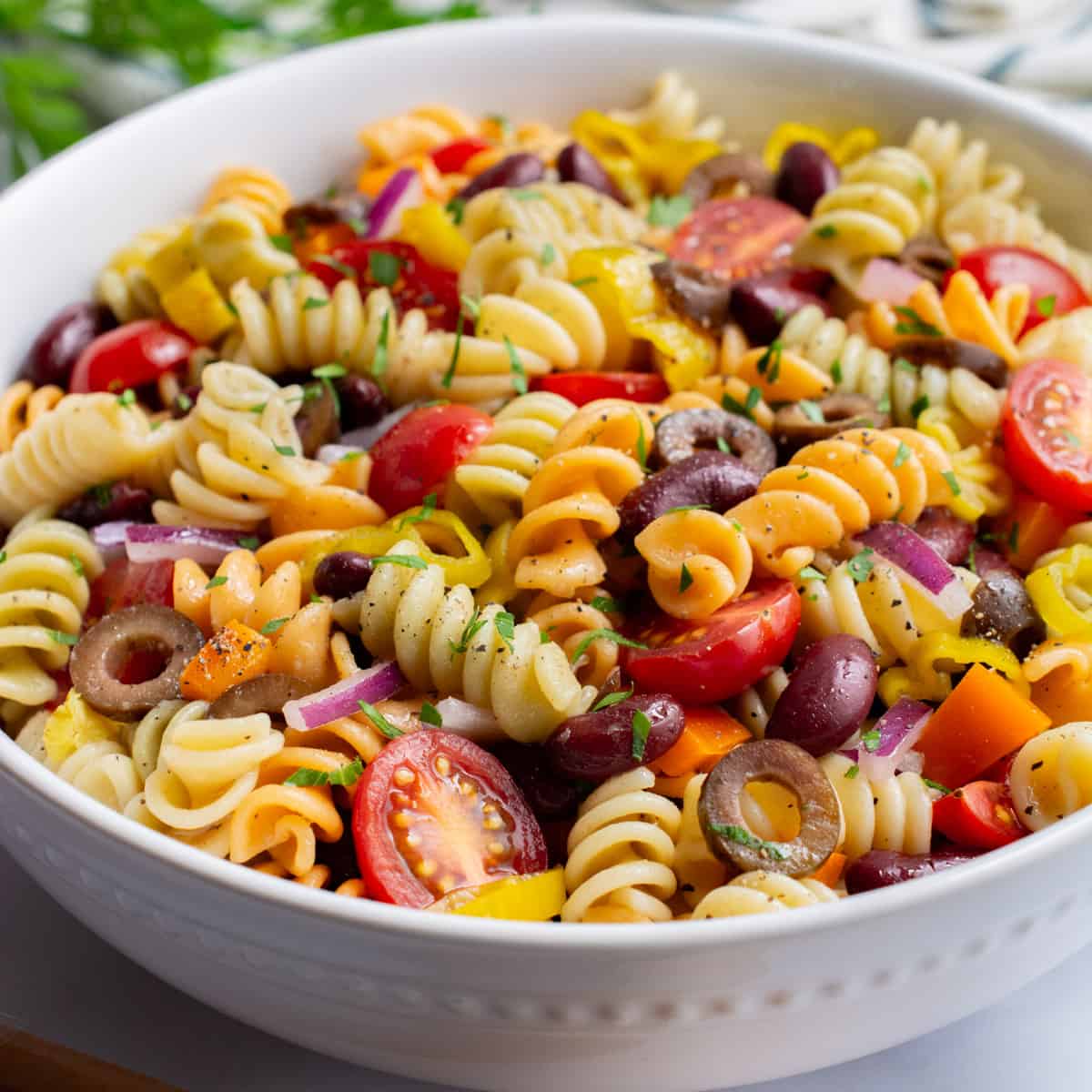 vegan pasta salad in a white serving bowl.
