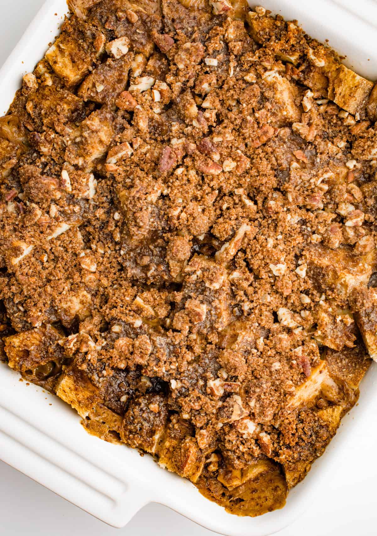 Vegan baked french toast after baking in a square white casserole dish.