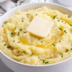 Mashed potatoes topped with vegan butter and chives.
