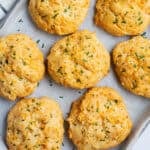 Vegan cheddar bay biscuits on parchment paper.