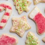 Sugar cookies cut into Christmas shapes and decorated with frosting and sprinkles.
