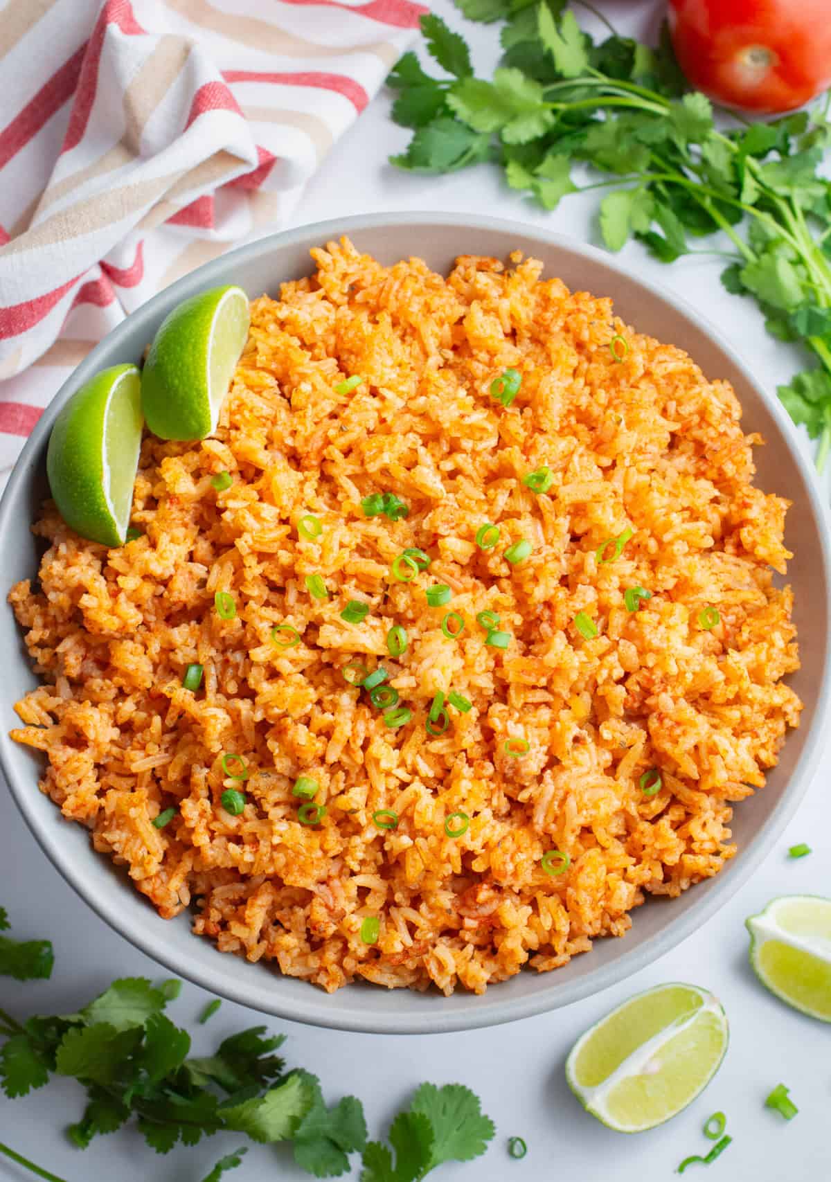 Looking down on Spanish rice topped with green onions.
