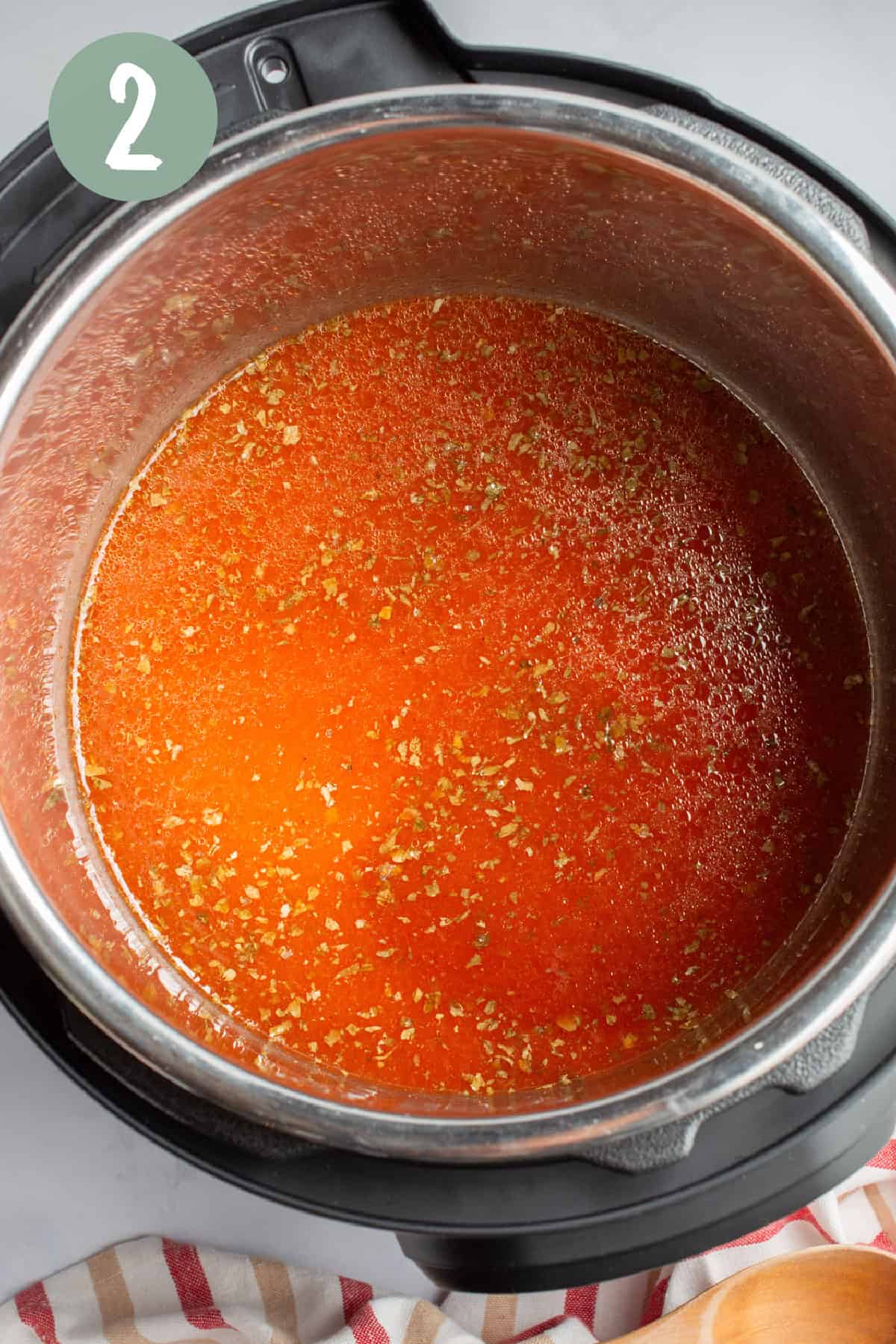 Rice, tomato sauce, water, and spices in an Instant Pot.