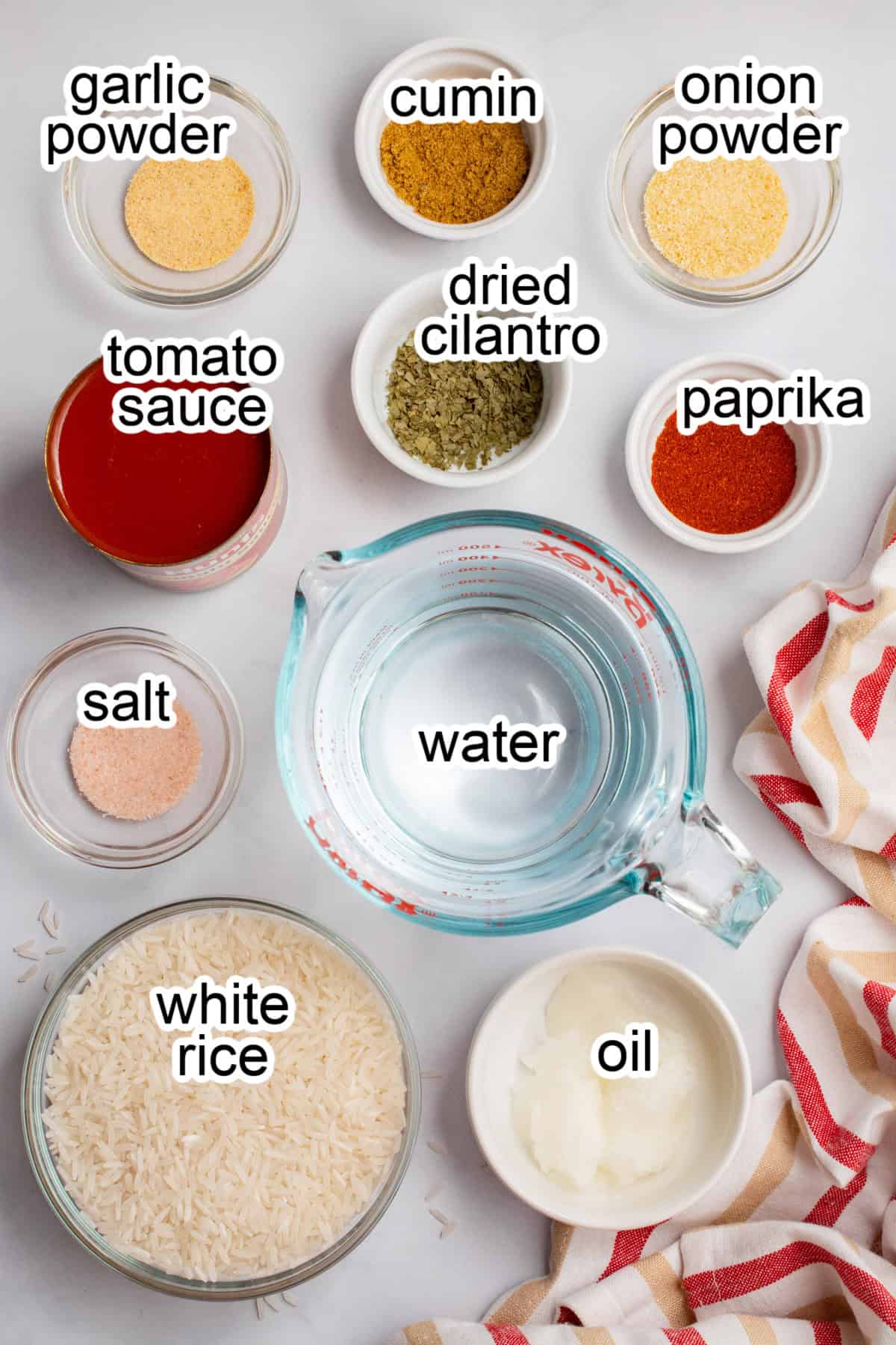 Rice, water, and spices in separate bowls.