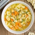 Vegetable noodle soup in a white bowl.