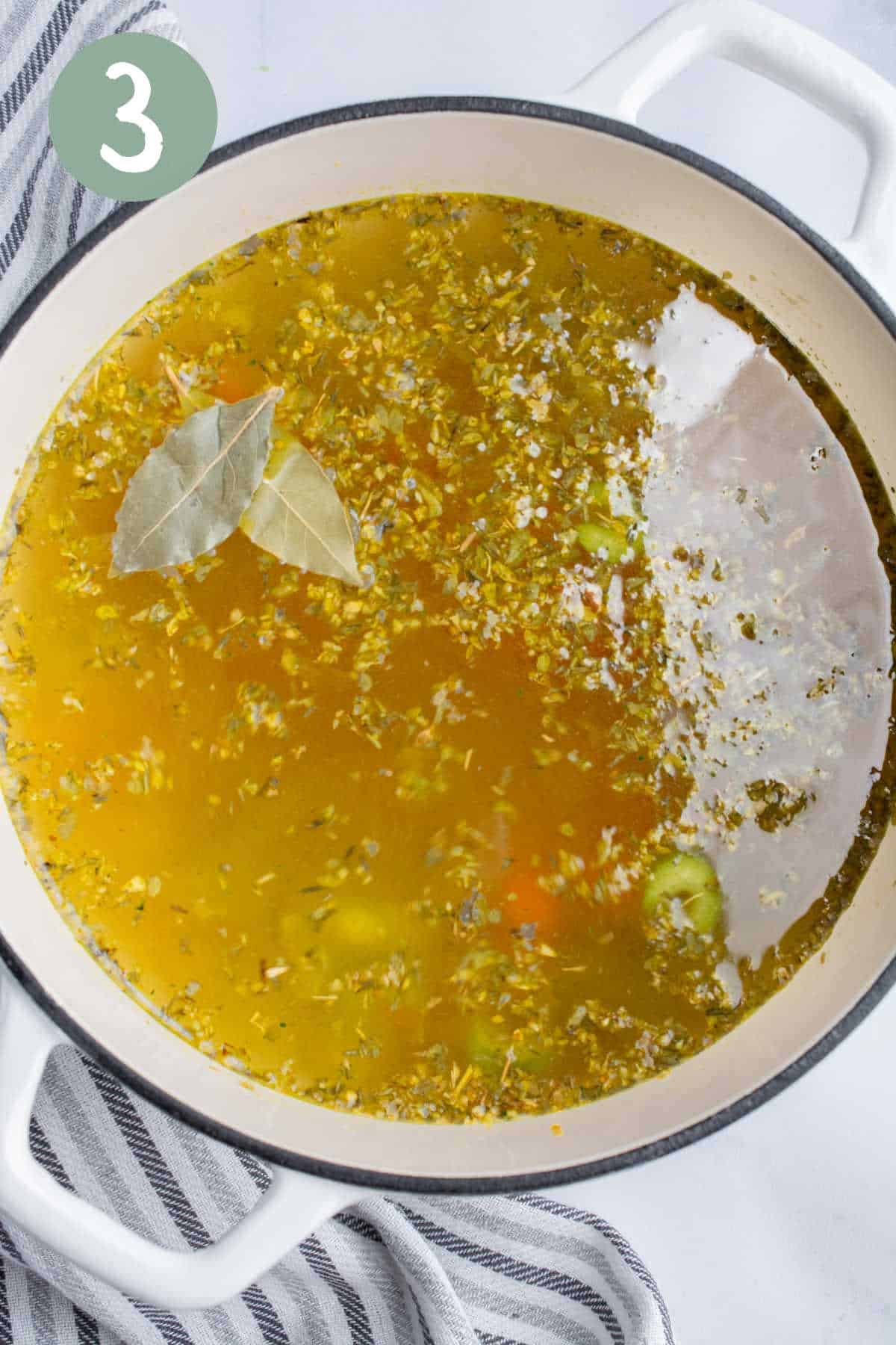 Broth and seasonings in a soup pot.