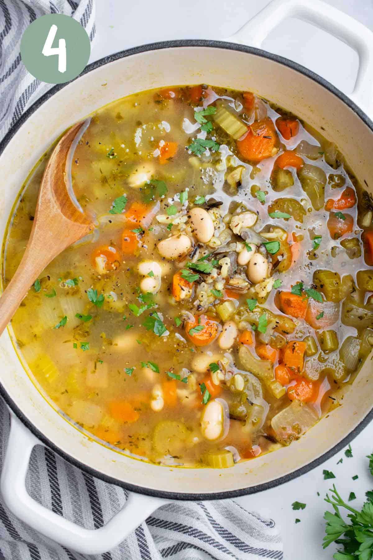 Wild rice soup in a white pot.