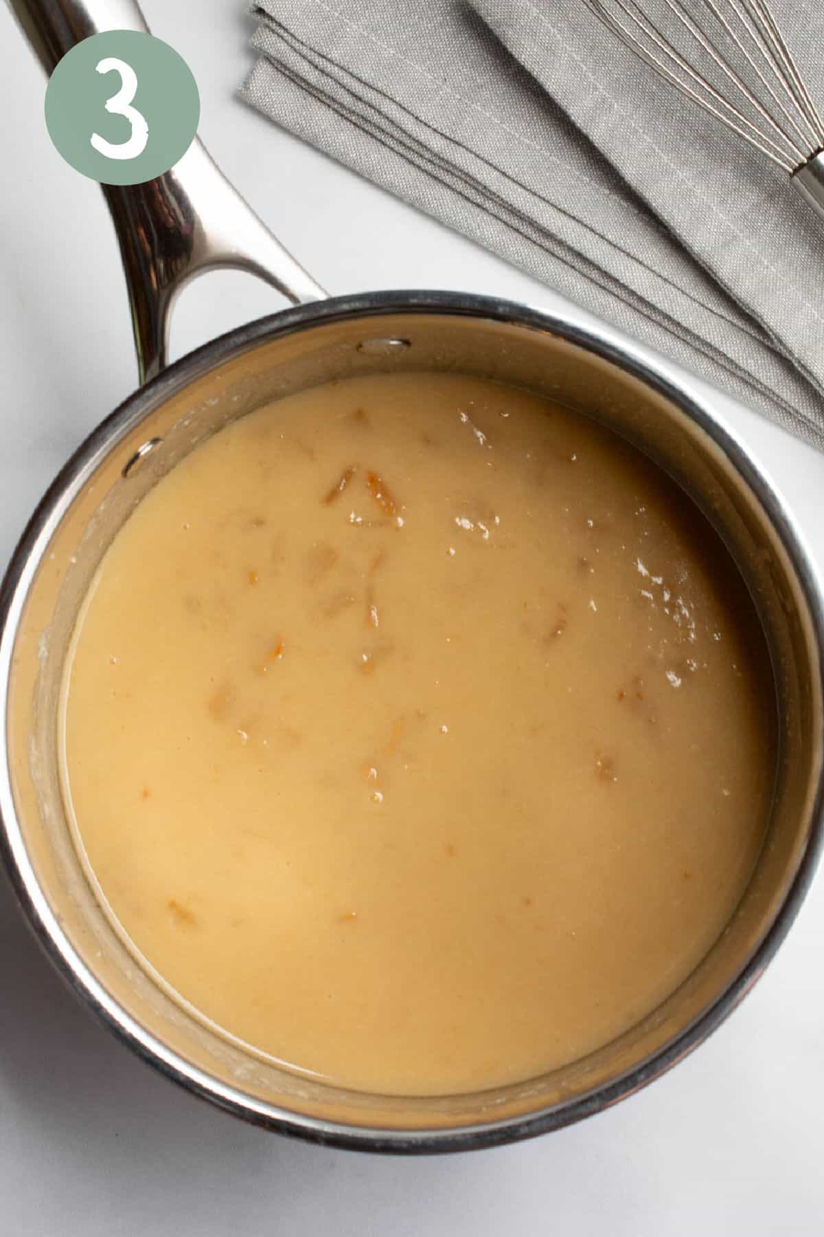 Onion gravy in a saucepan.