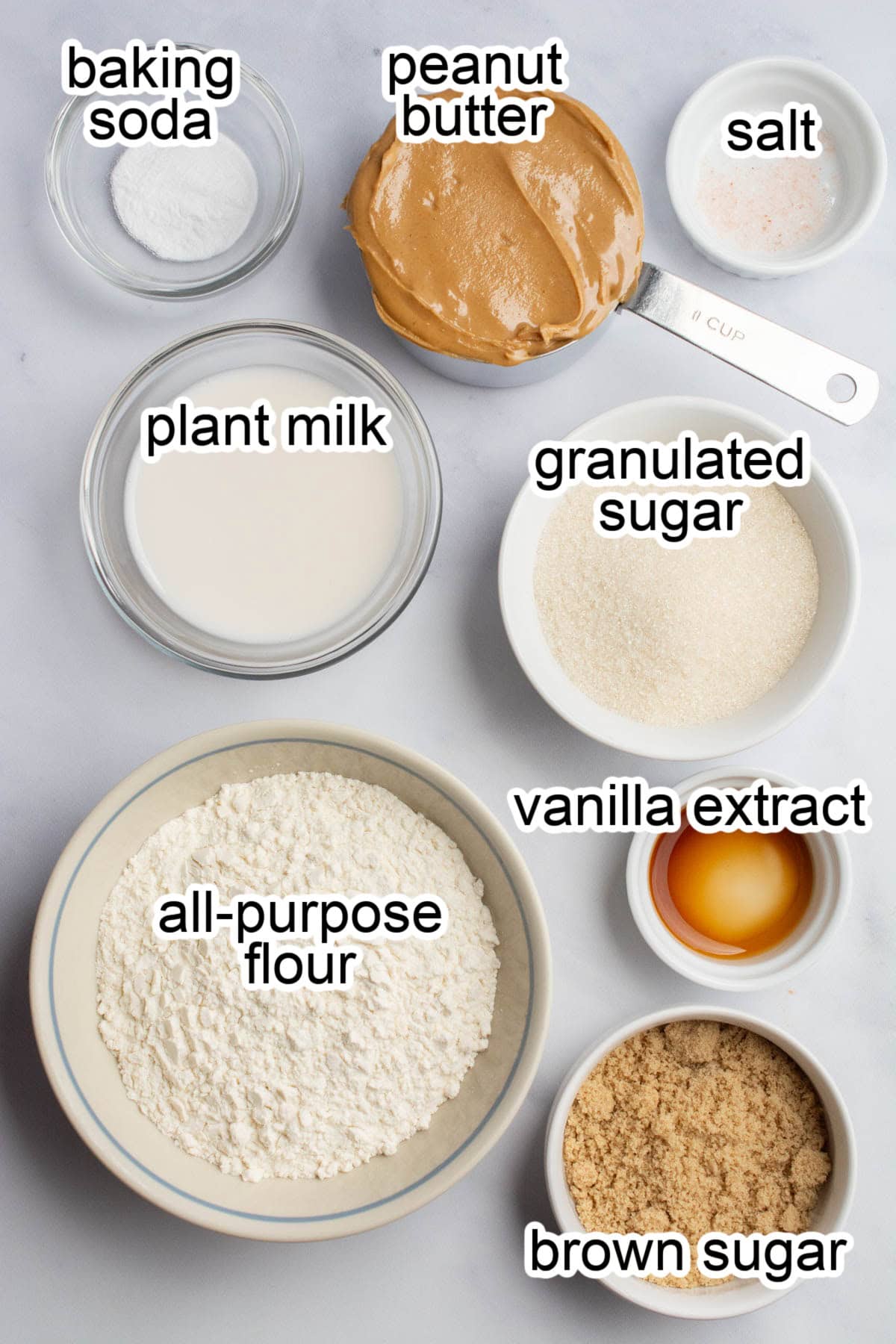 Bowls of ingredients to make vegan peanut butter cookies.