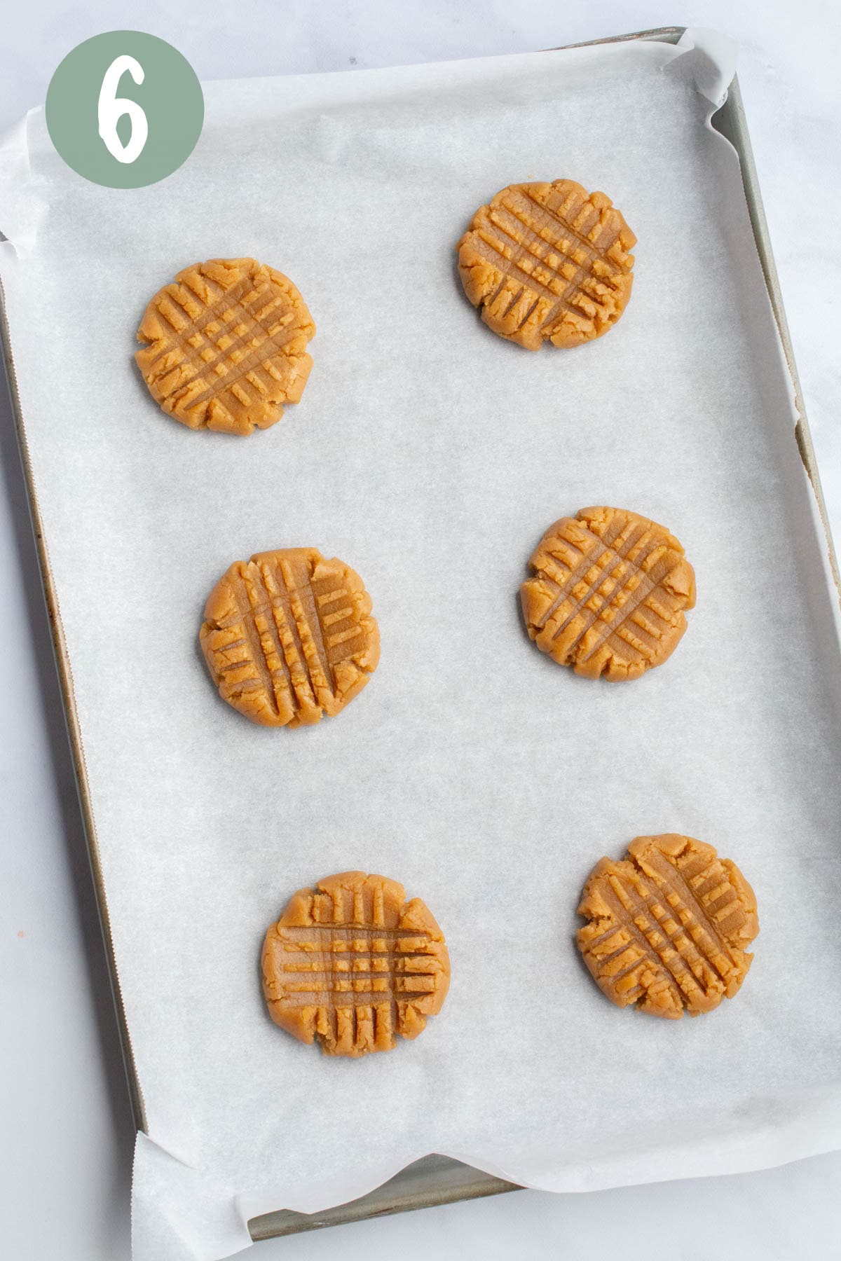 Vegan peanut butter cookie dough cross-hatched with a fork.