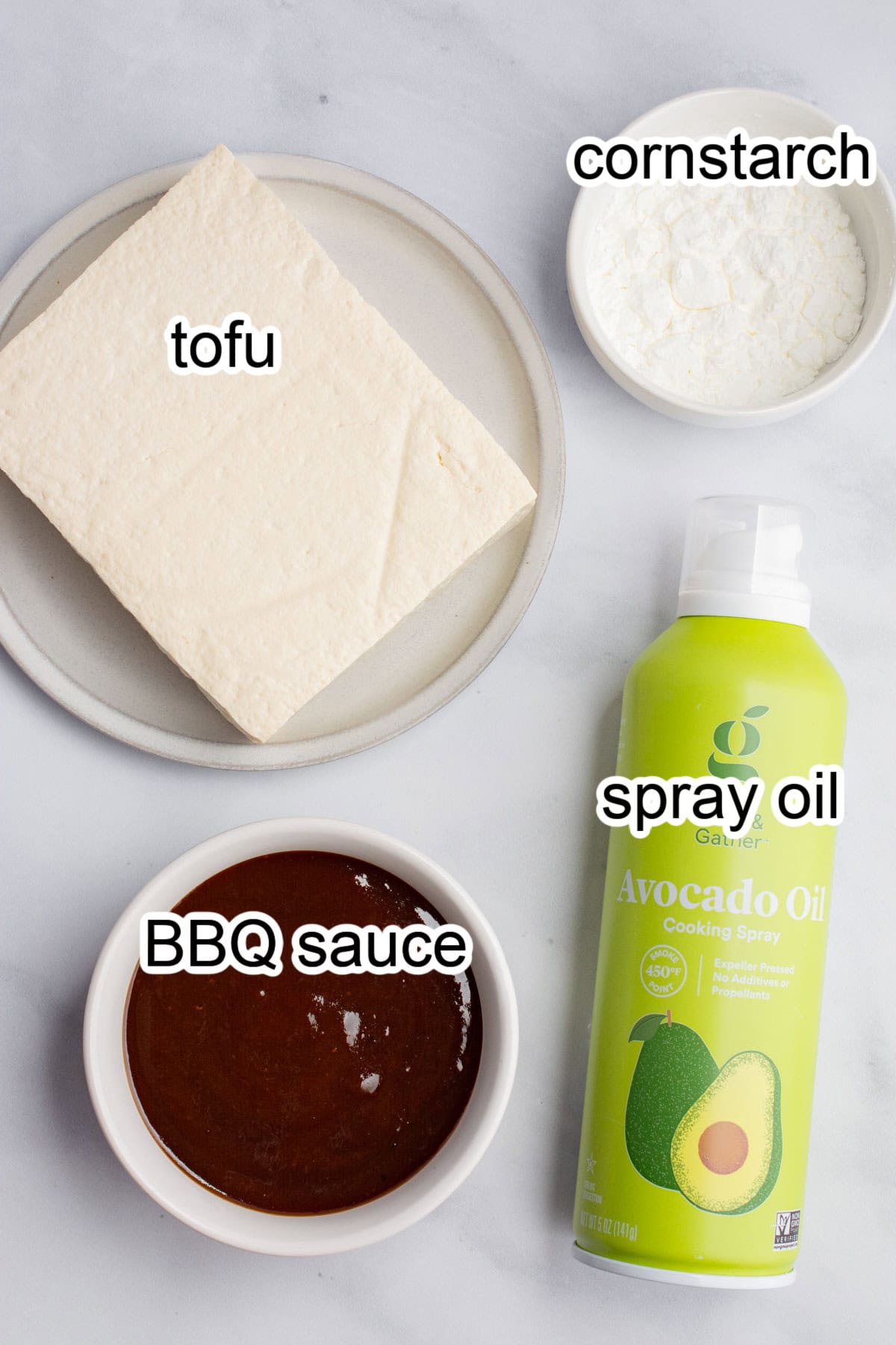 Ingredients for BBQ tofuL tofu block. cornstarch, bbq sauce, and spray oil.