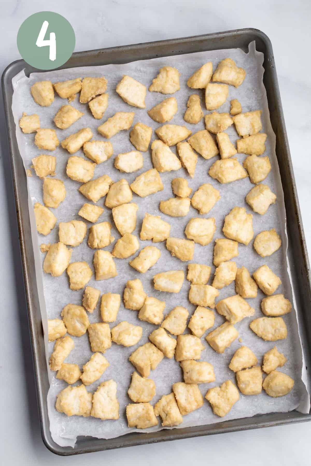 Tofu chunks on a baking sheet after baking.