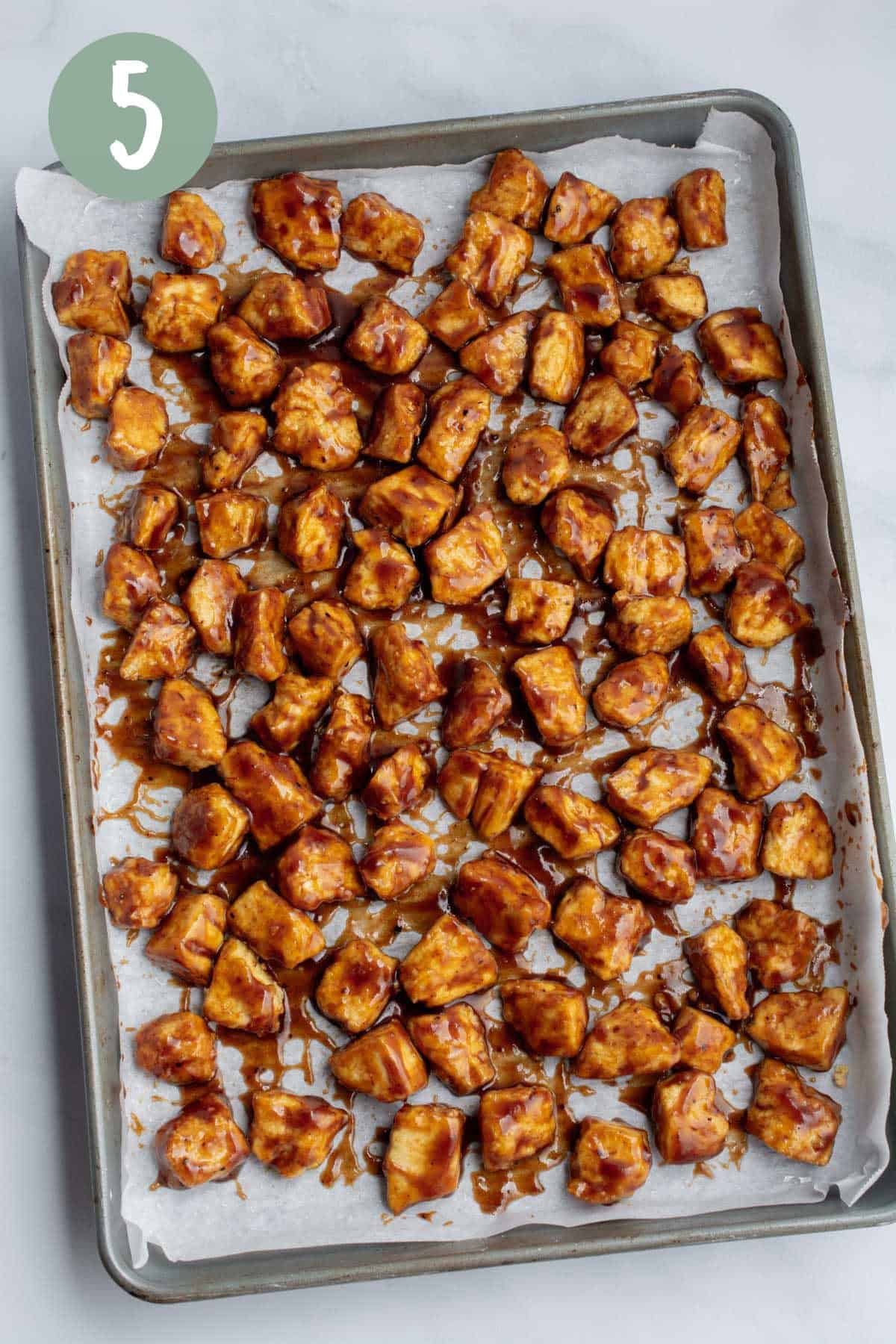 Tofu chunks covered in bbq sauce.