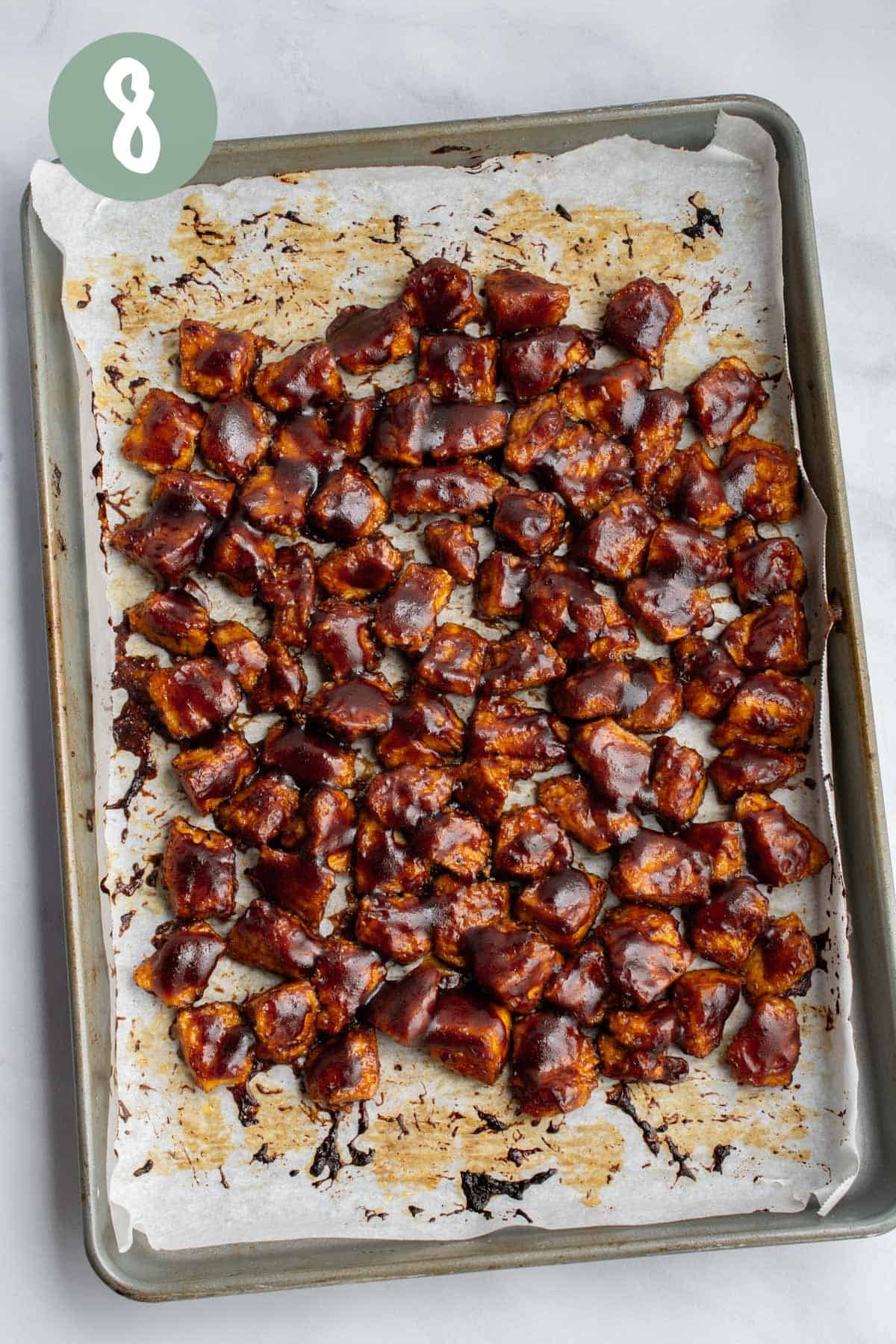 Baked BBQ tofu on a baking sheet.