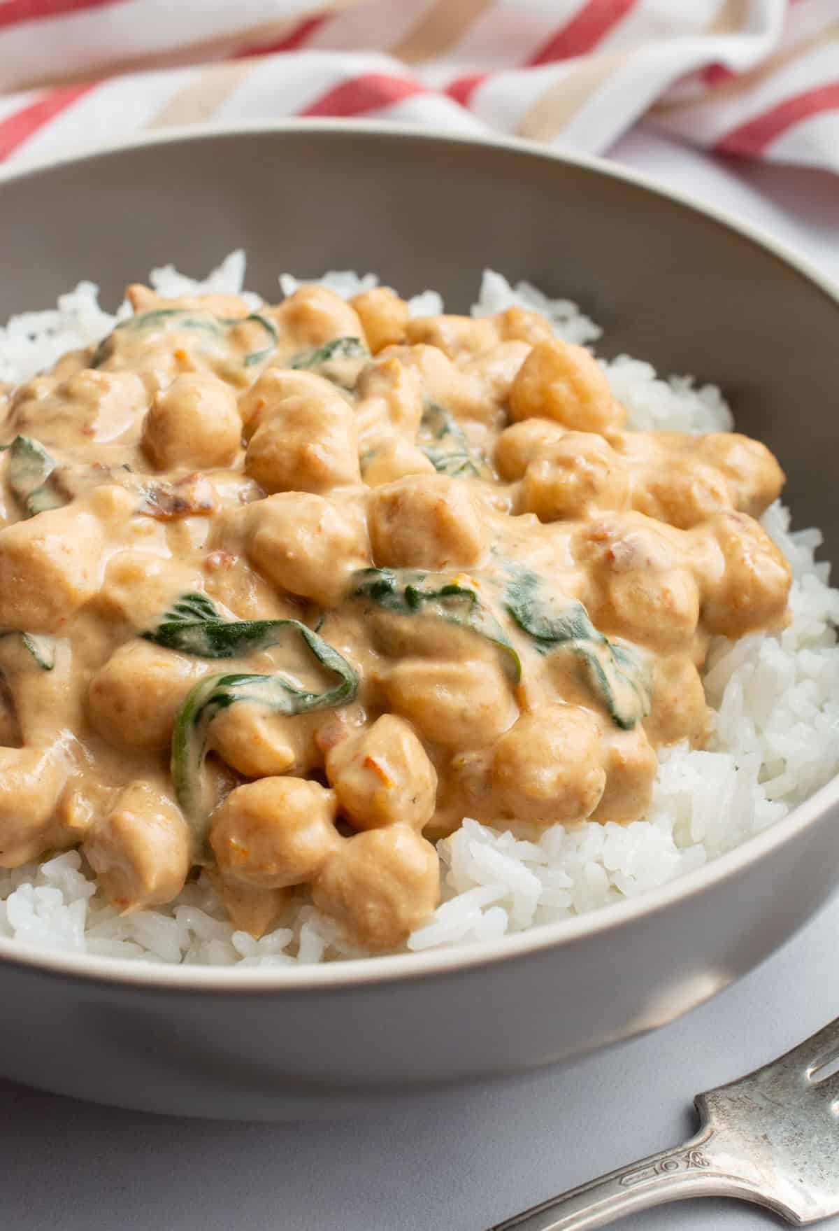 A bowl of marry me chickpeas over white rice.
