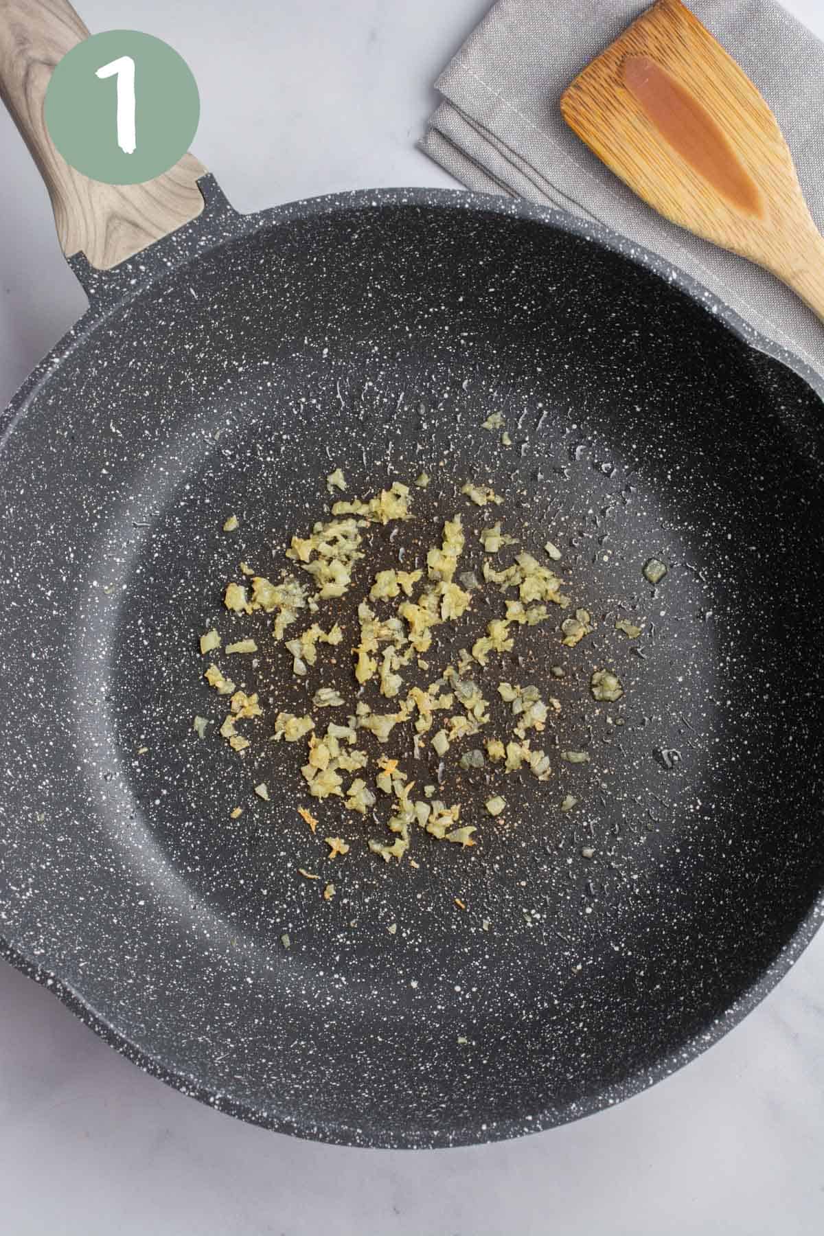 A pan with sautéed garlic.