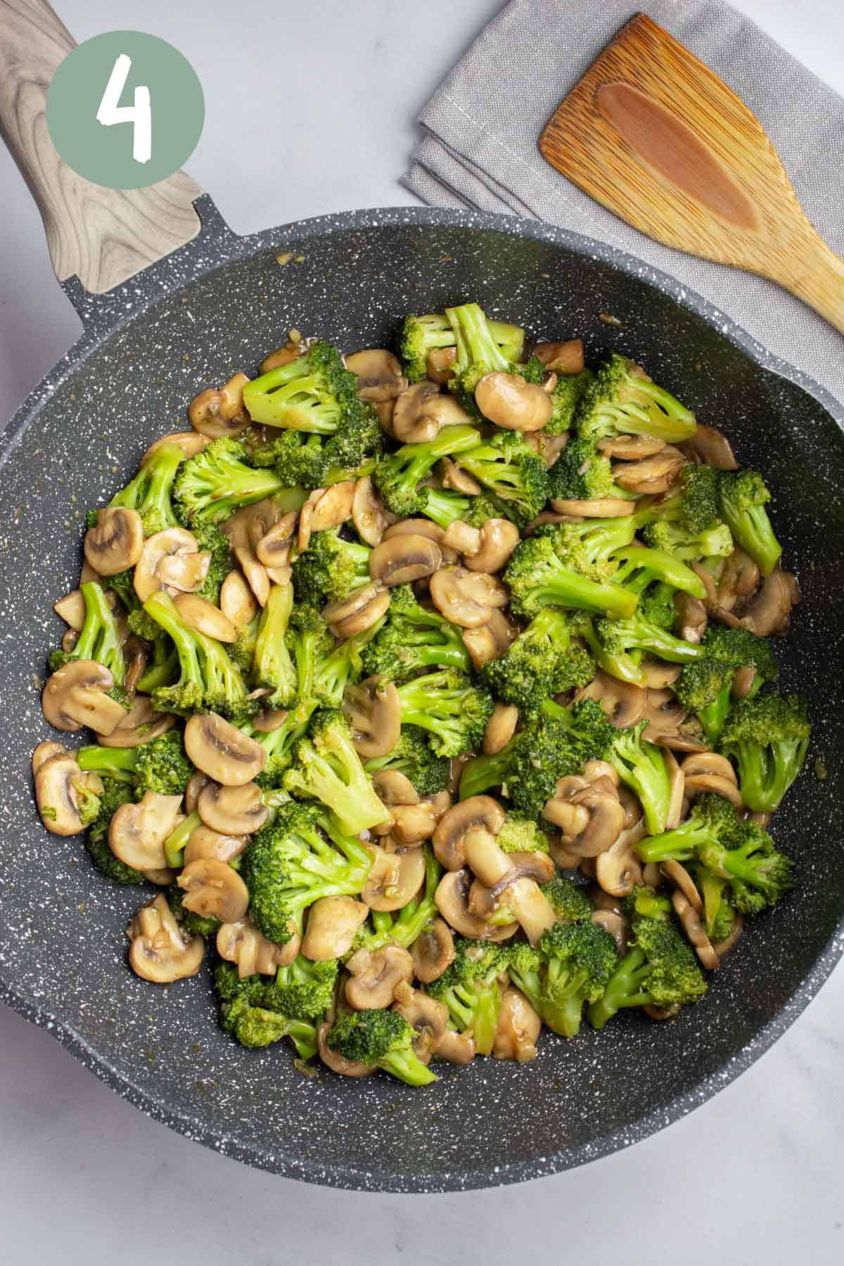 A pan of broccoli and mushroom stir-fry.