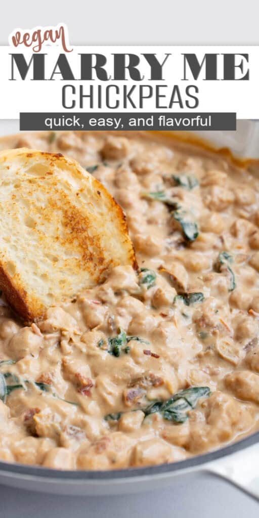 A skillet with creamy chickpeas and a slice of toasted french bread.