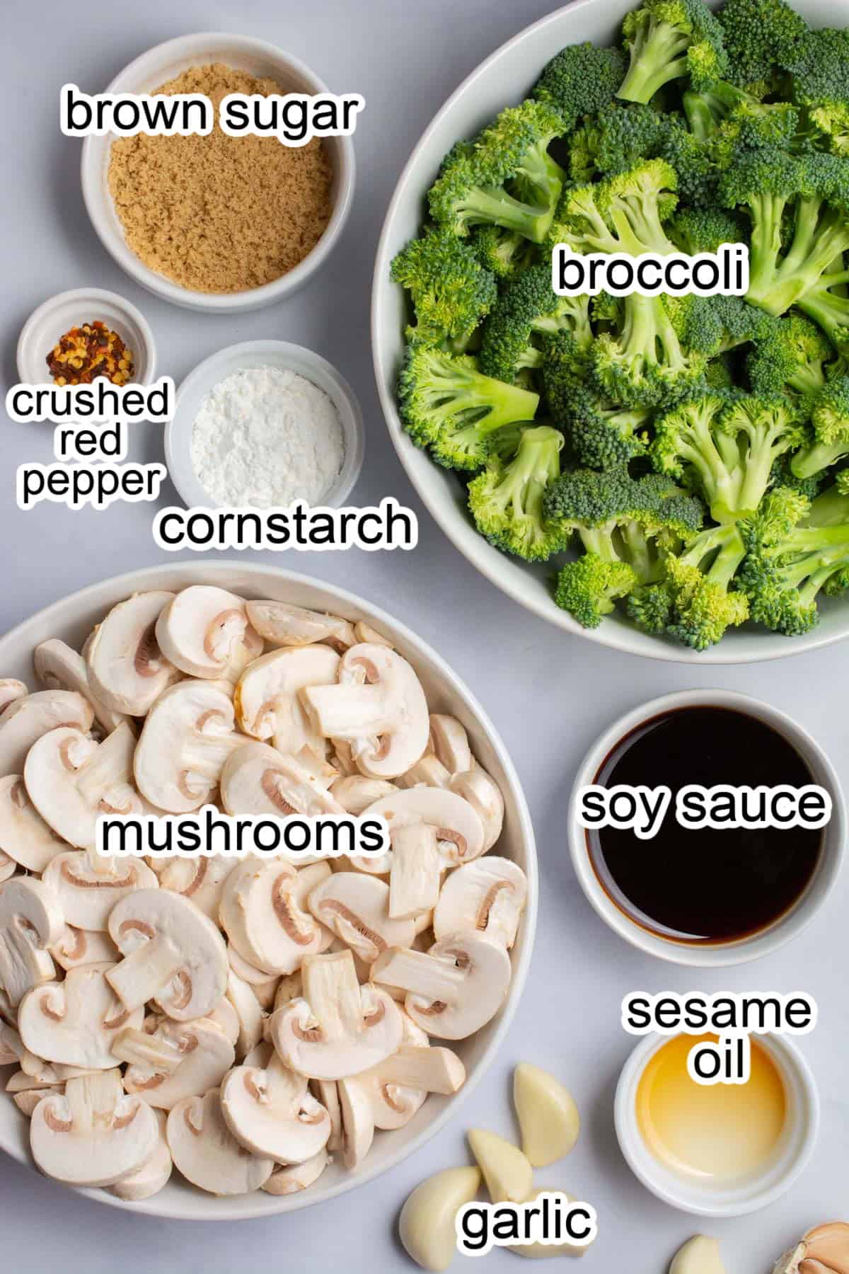 bowls of ingredients to make a broccoli and mushroom stir-fry.